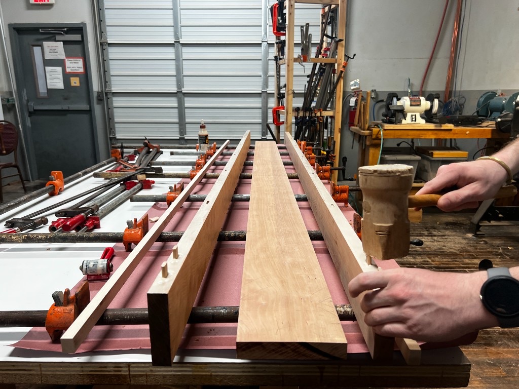 Wooden mallet seating a joint on a workbench